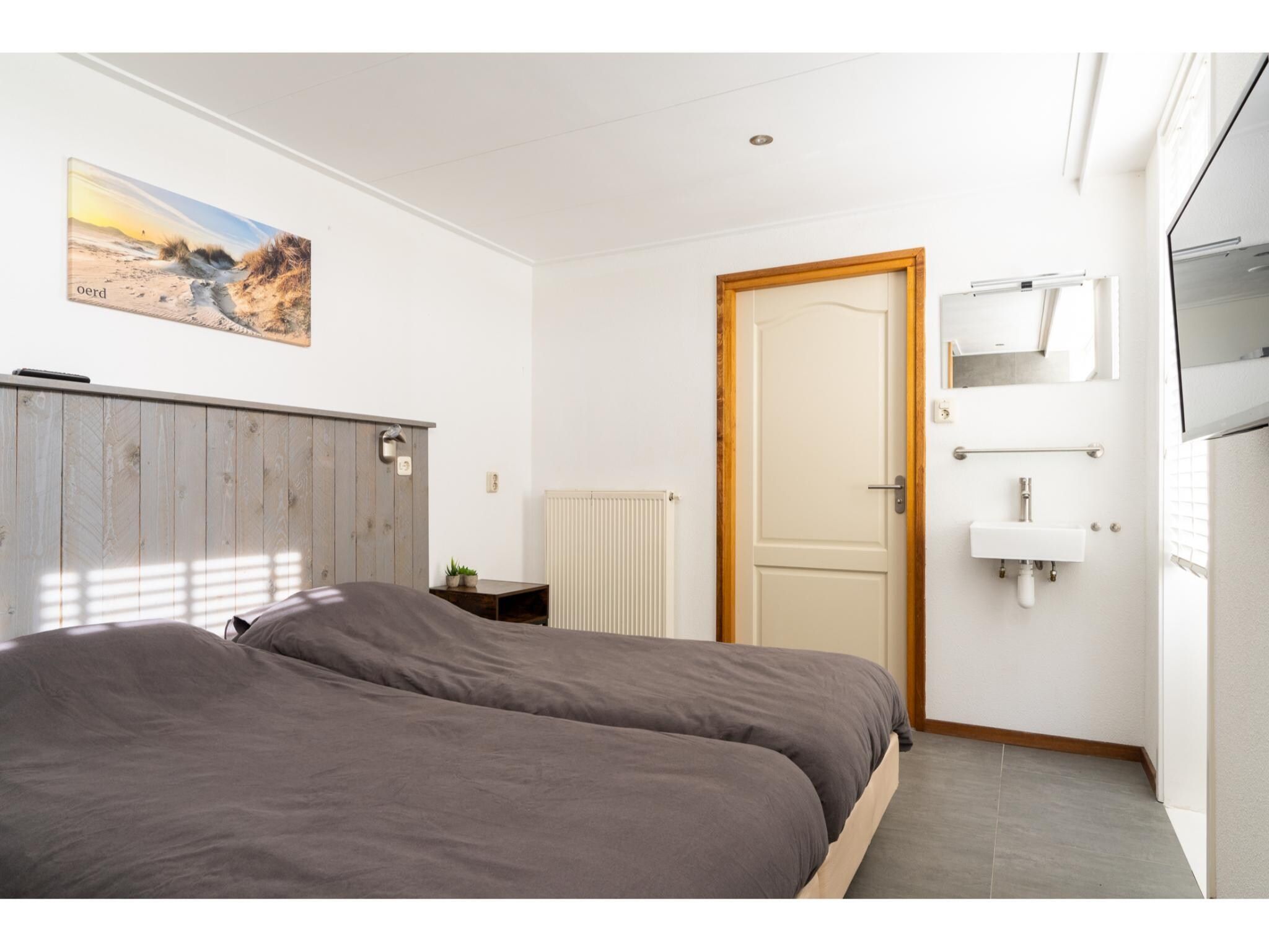 Een slaapkamer van Golfvilla 39 Wellness in Hollum