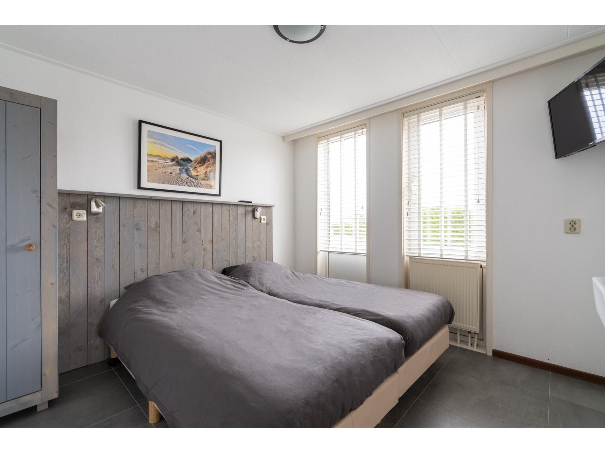 Een slaapkamer van Golfvilla 39 Wellness in Hollum