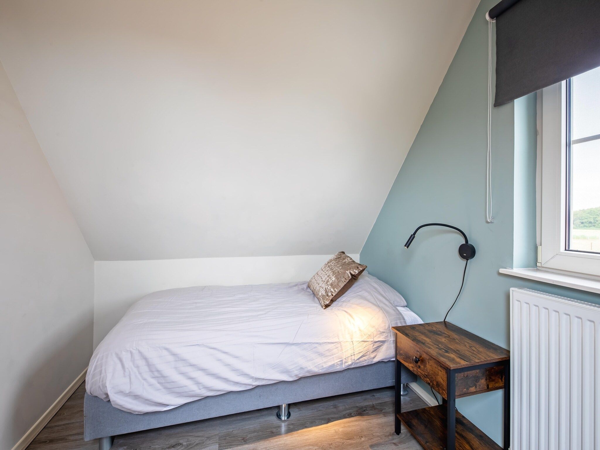 Een slaapkamer van Wulpenweid 12 in Den Burg