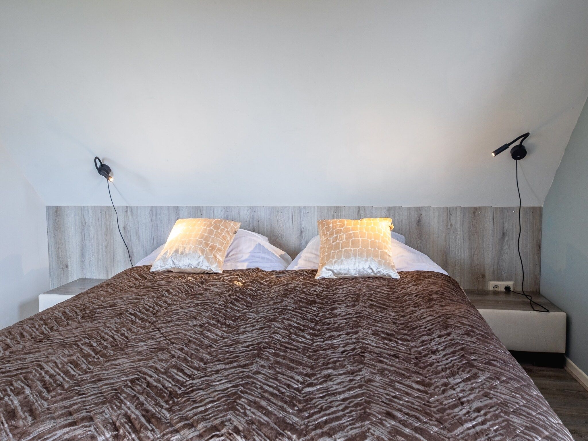 Een slaapkamer van Wulpenweid 12 in Den Burg