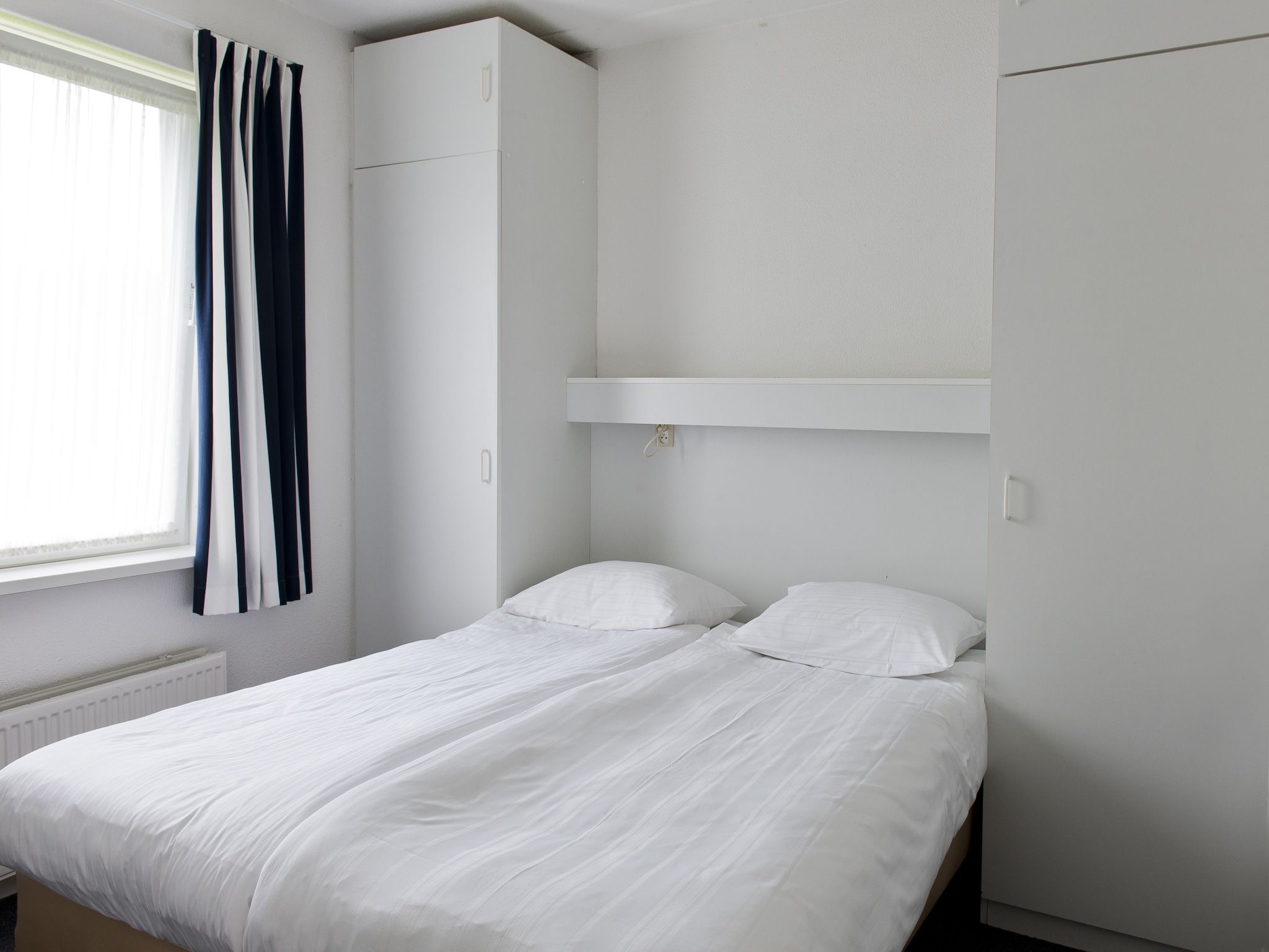 Een slaapkamer van Grand Tolve Wellness de luxe met sauna buitenspa & sloep in Earnewald