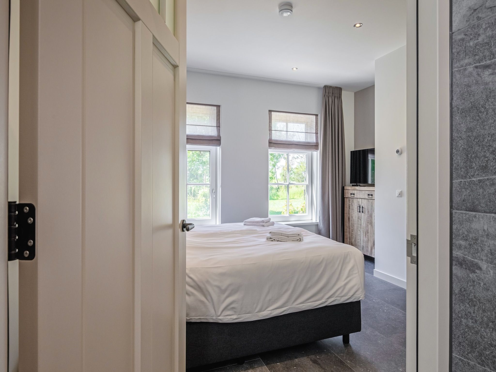 Een slaapkamer van Familievilla Nieuw-Zeeland in Oosterend