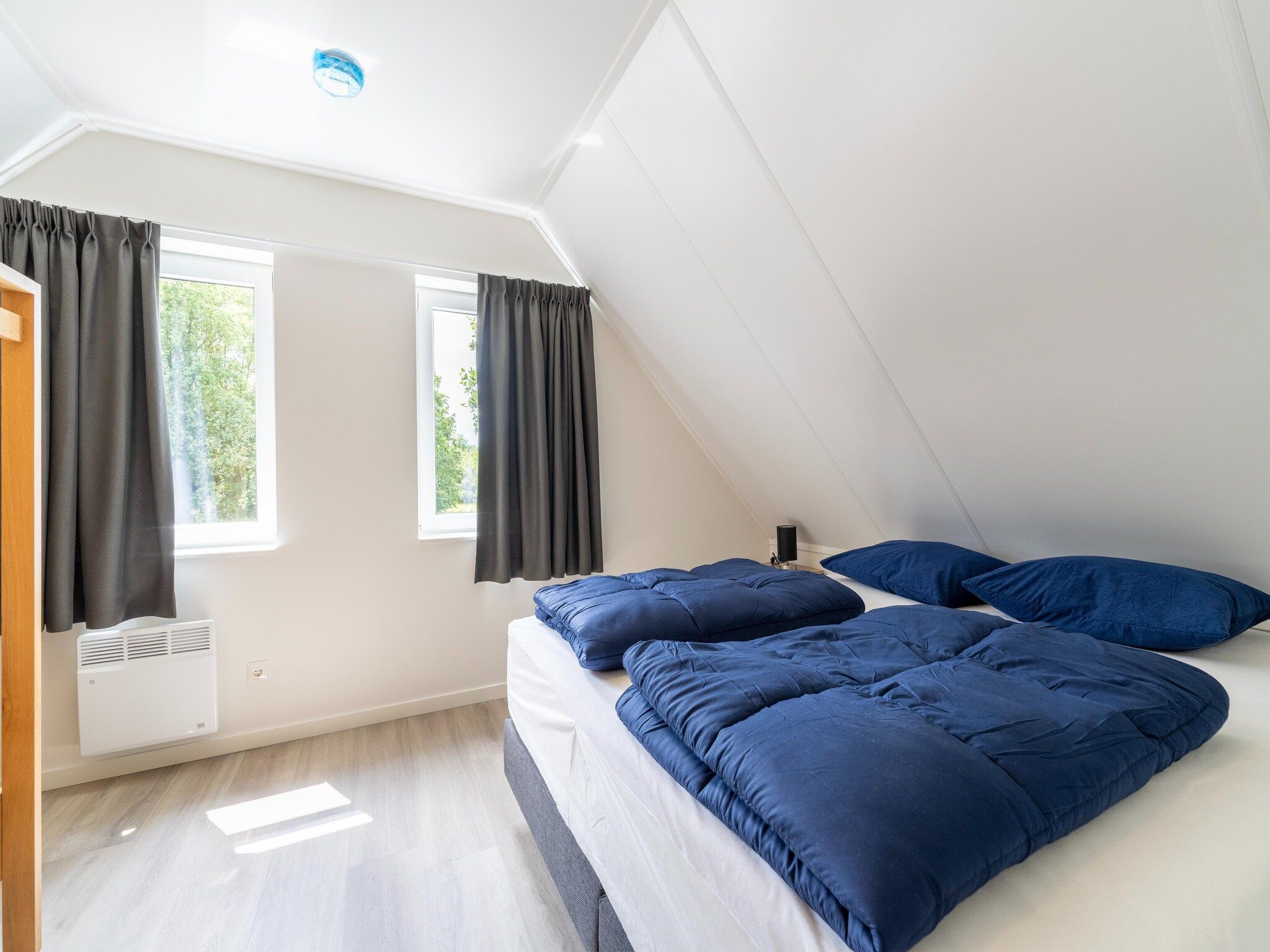 Een slaapkamer van Kuifduiker 5 in Simonshaven