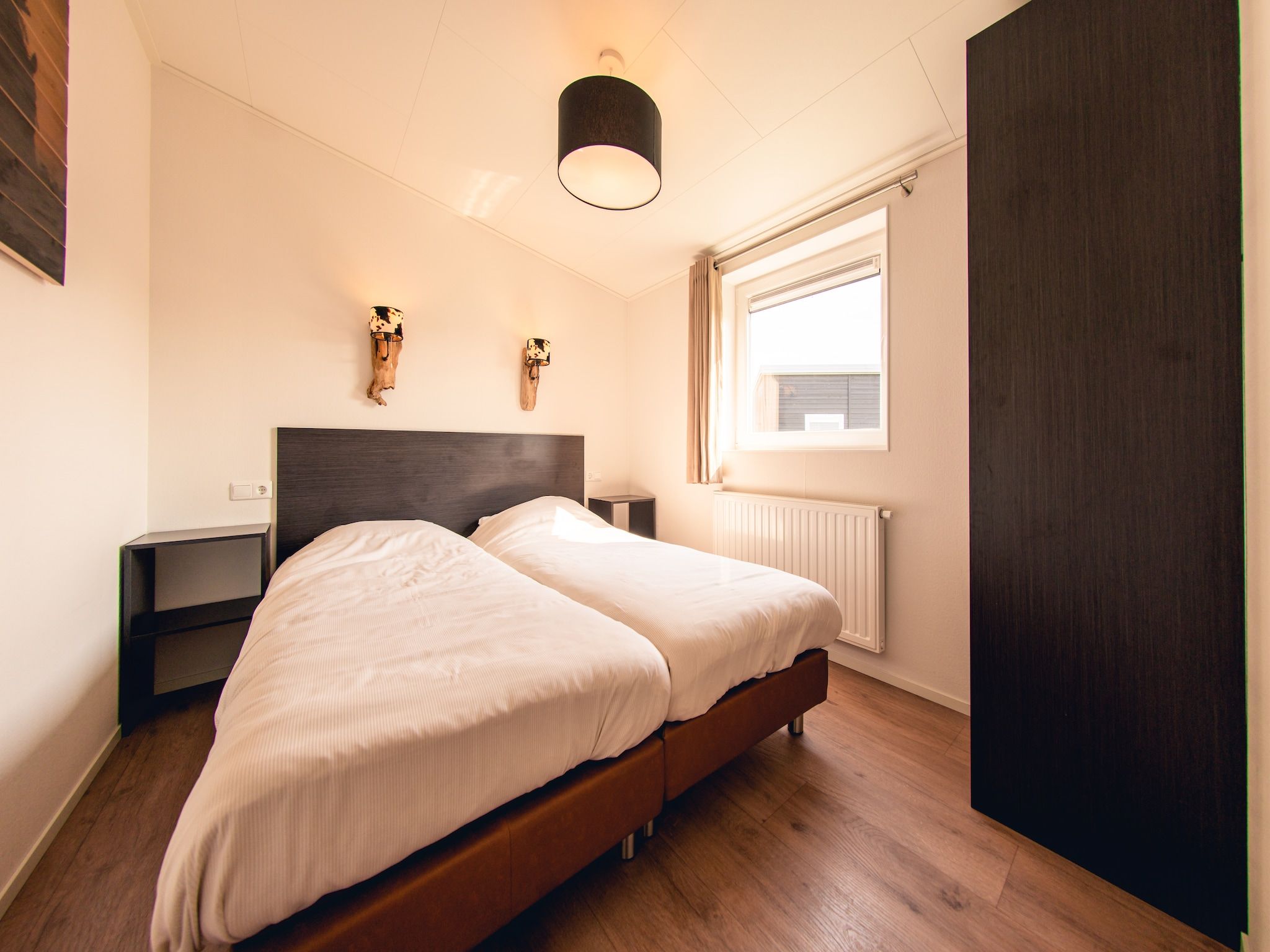 Een slaapkamer van Raccoon Lodge in Slagharen