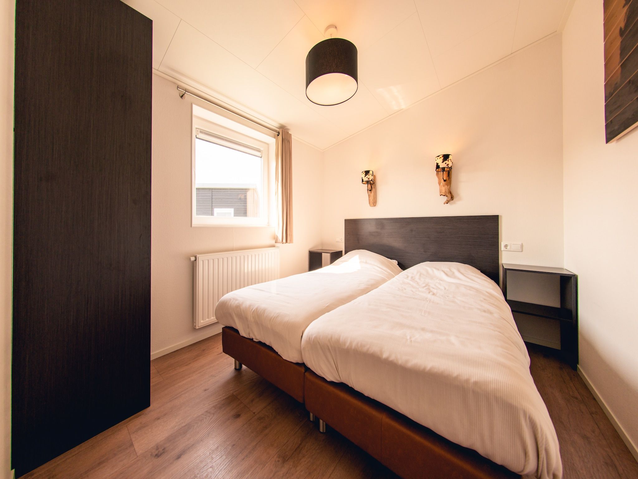 Een slaapkamer van Raccoon Lodge in Slagharen