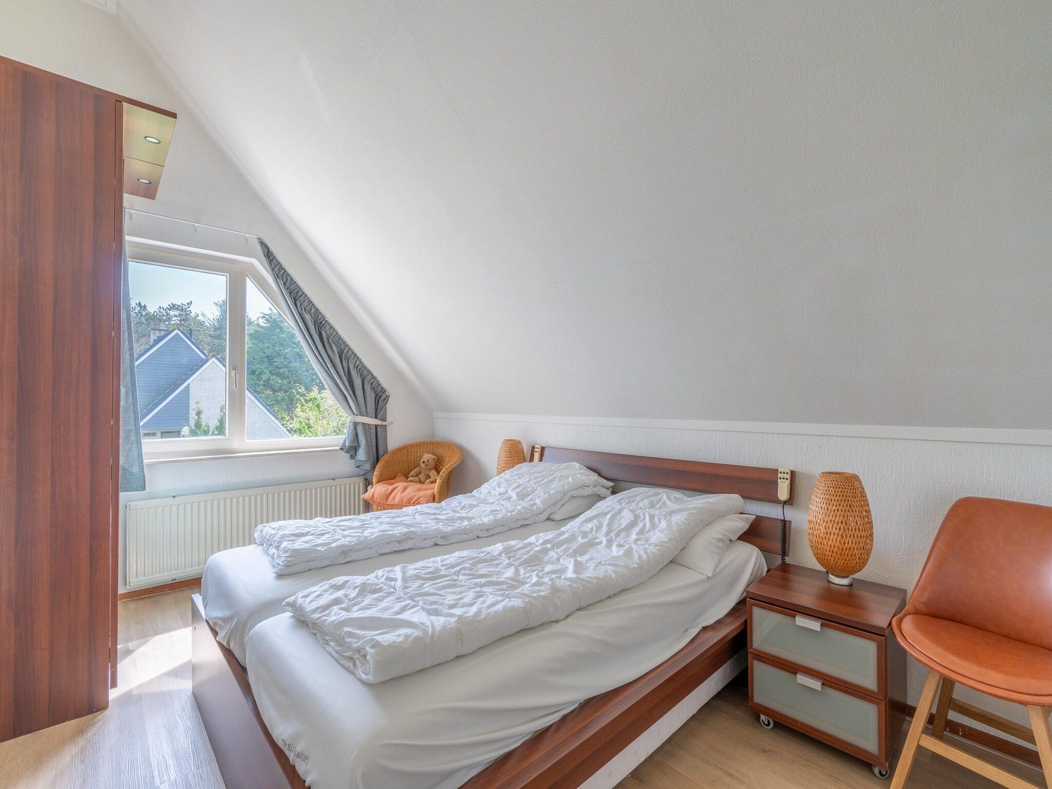 Een slaapkamer van Kamperfoelie 61 in De Koog