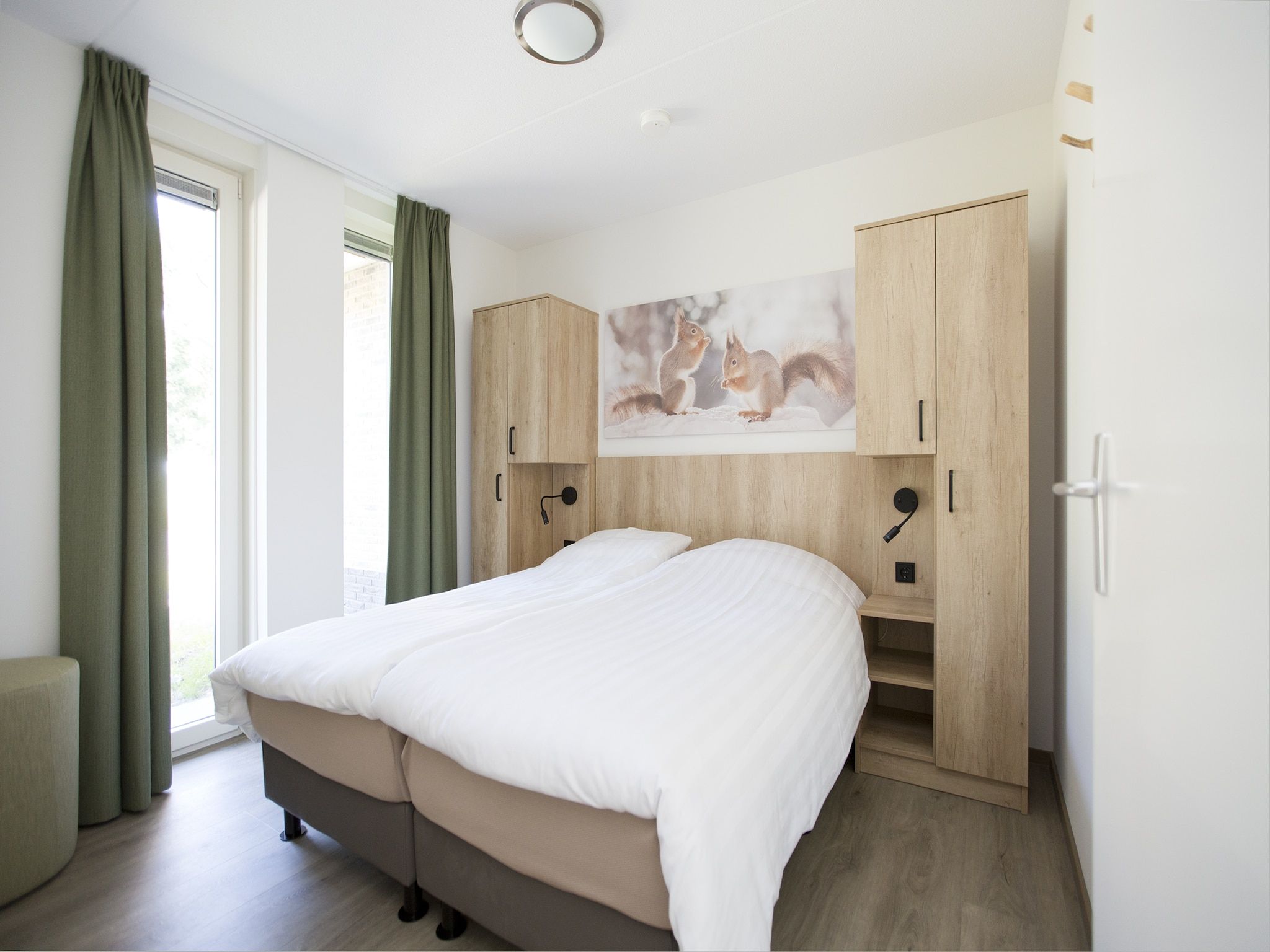 Een slaapkamer van Landgoed De IJsvogel 6 in Voorthuizen