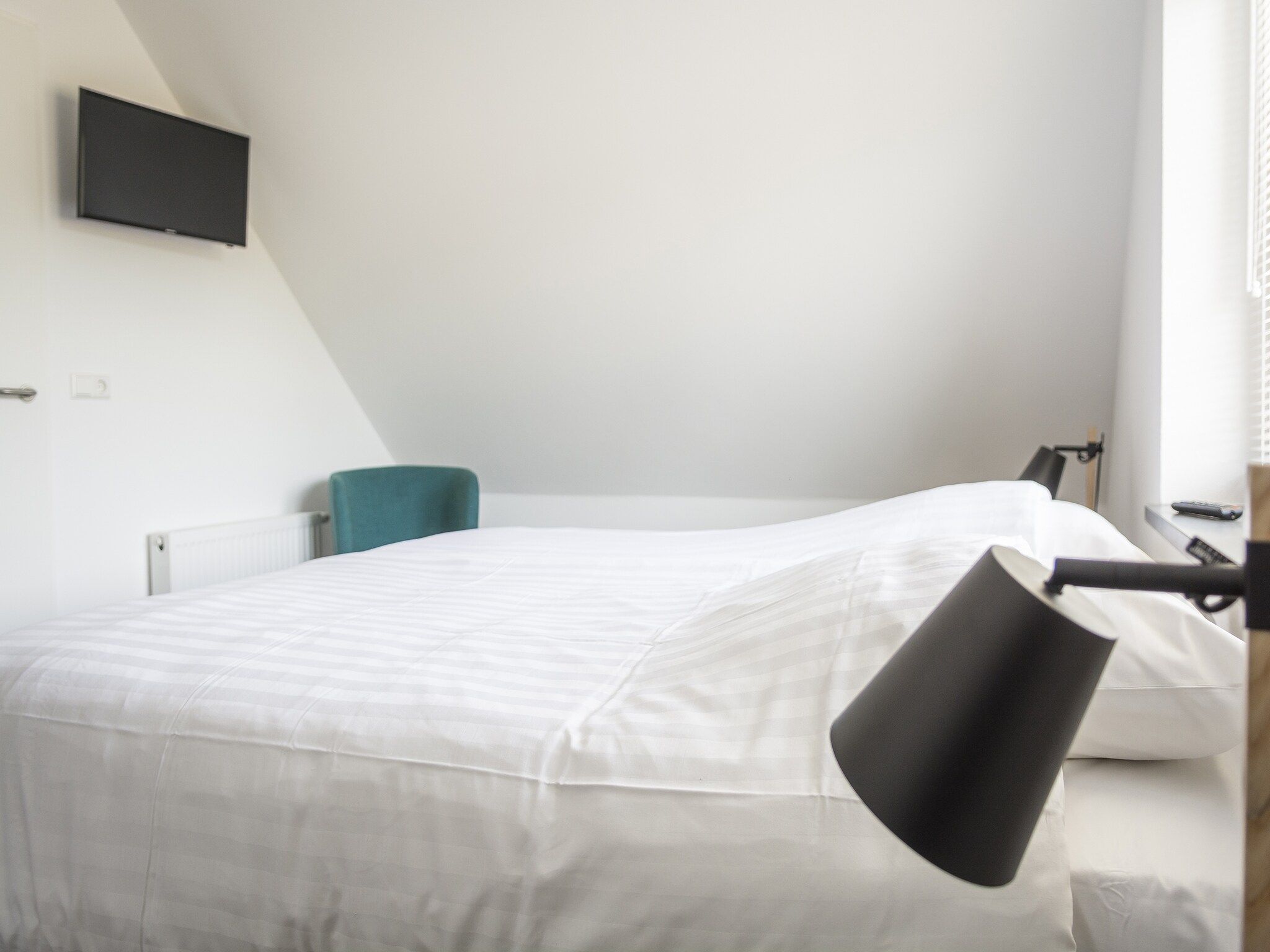 Een slaapkamer van Landhuis Bouwlust K in De Cocksdorp Texel