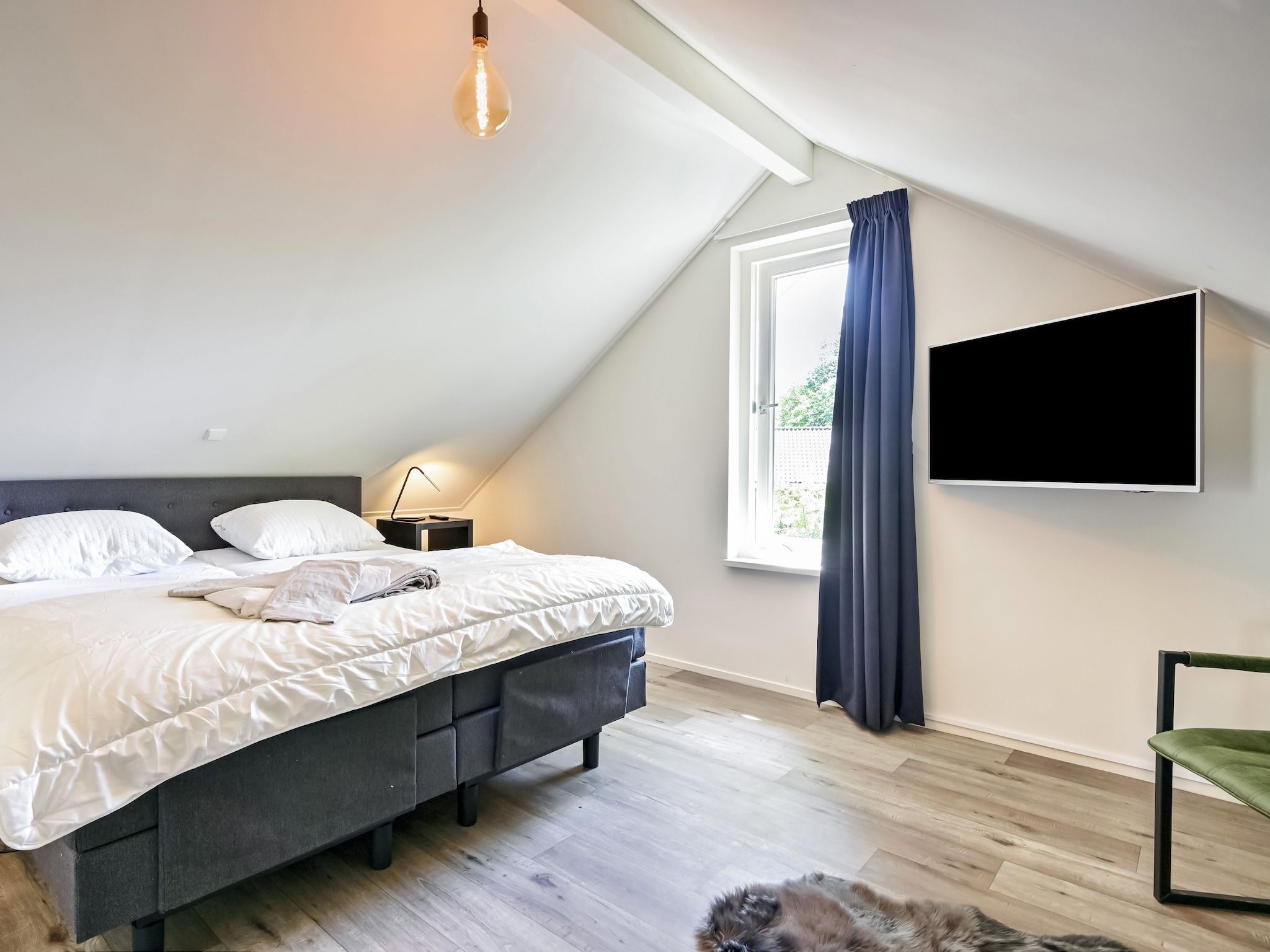 Een slaapkamer van Uitzicht in Reutum